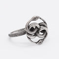 Detailed view of a titanium steel retro double snake ring in steel colour on a finger