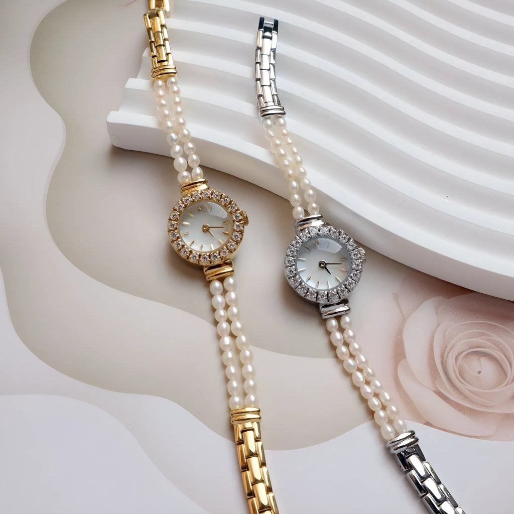 Women's light gold bracelet watch with freshwater pearls and a round 18mm dial.