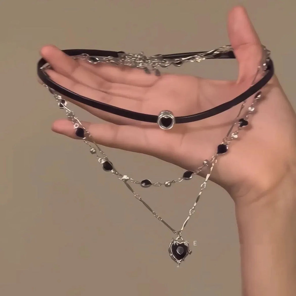 Women's creative double-layer necklace with heart-shaped crystal pendant and leather accents on an adjustable chain.