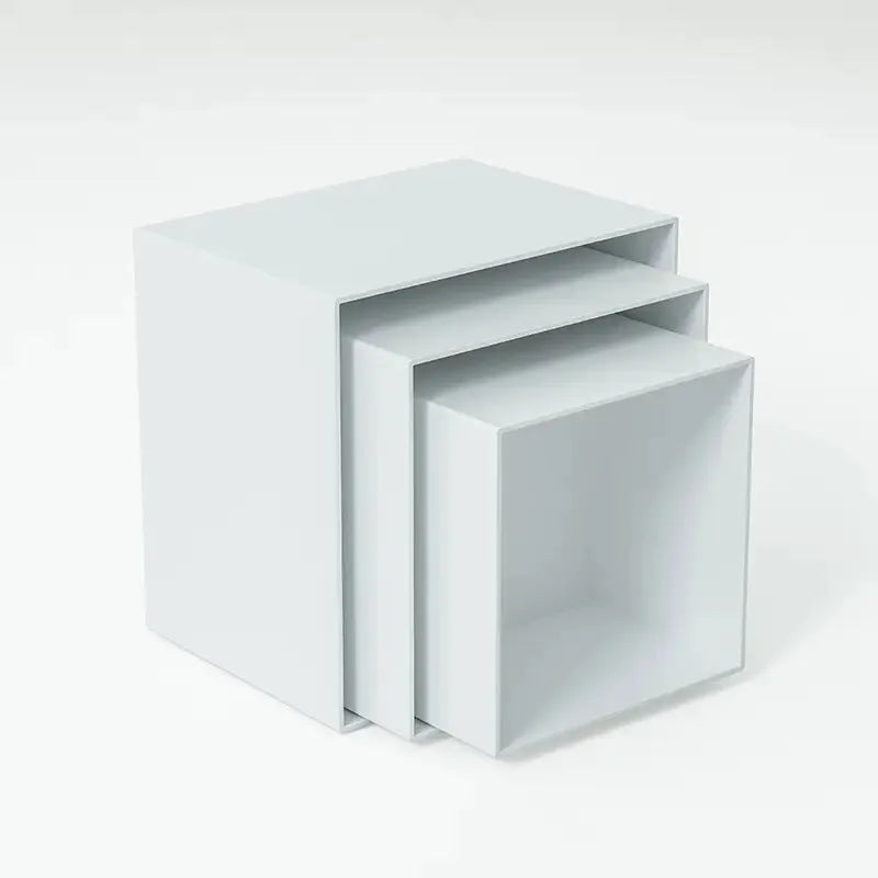 White plastic modular dessert display stand with six stackable suit cube racks on a table.