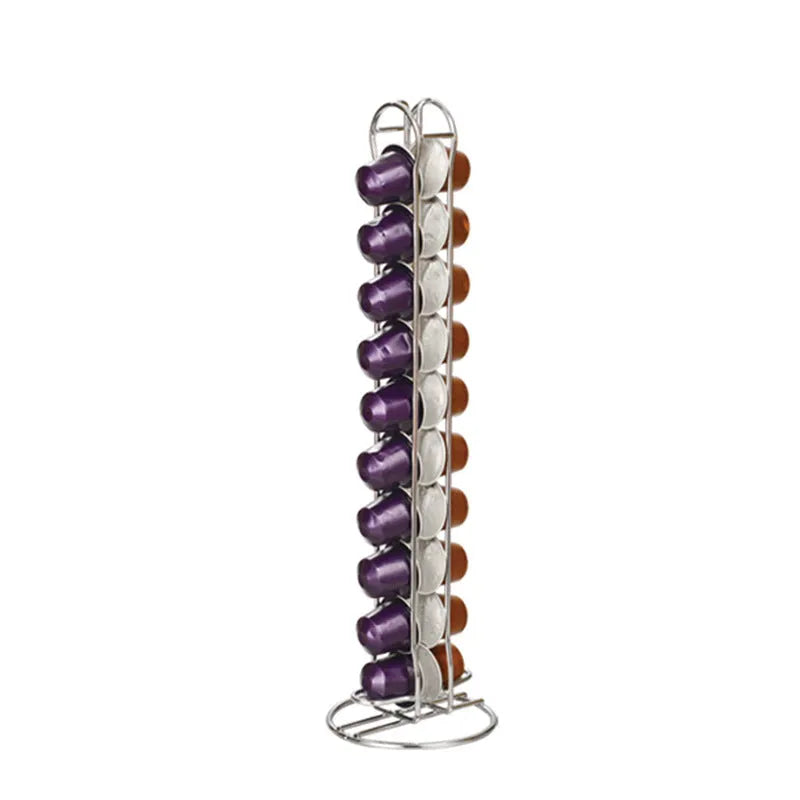 Black wrought iron coffee capsule storage rack displaying pods on a kitchen worktop.
