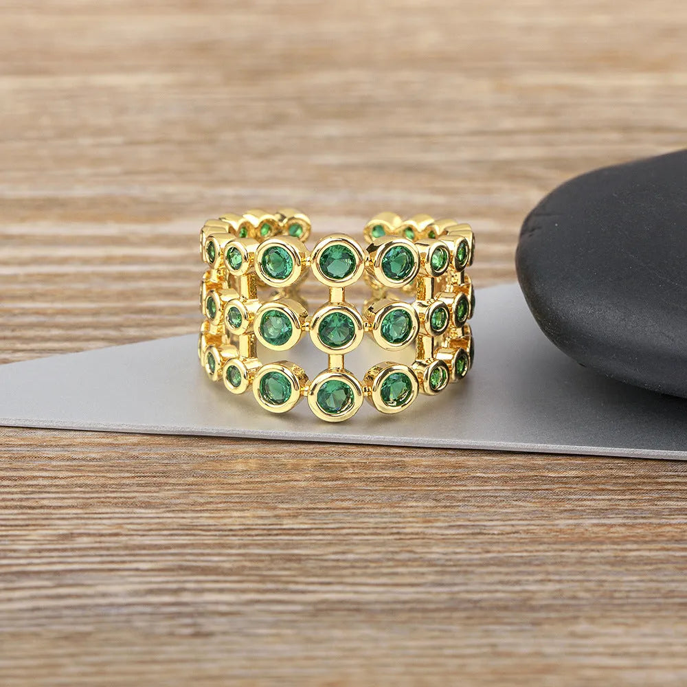 Copper ring with 18K gold plating and green zircon stones in wide band design