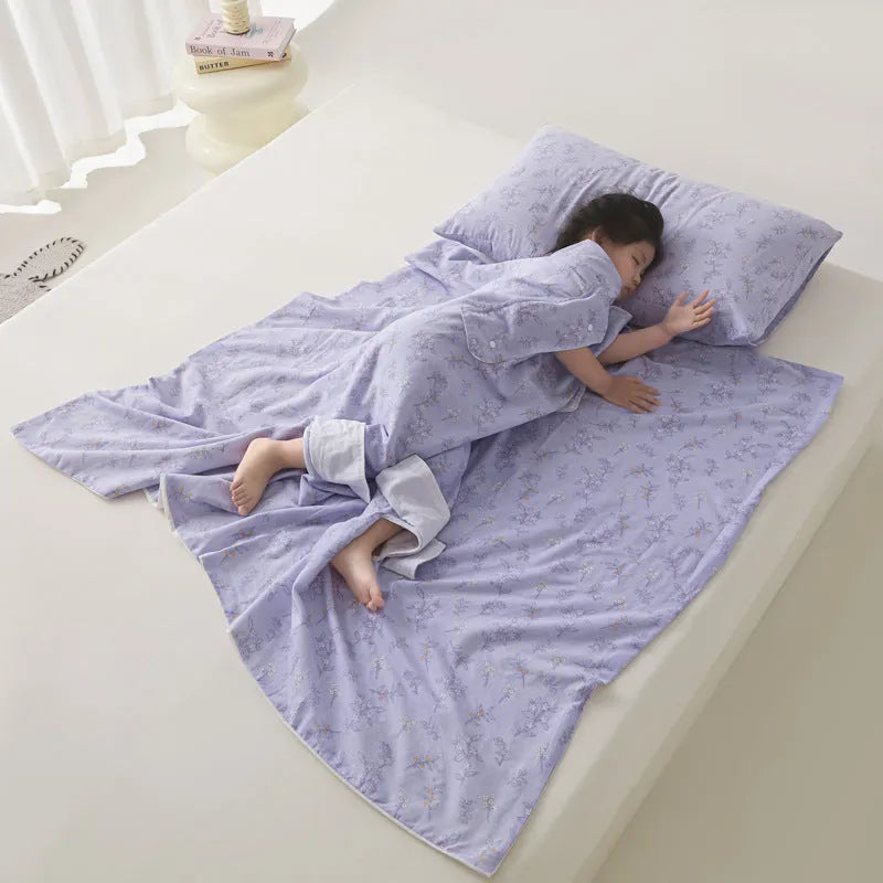 Anti-kick sleeping bag style blanket in a colourful pattern on a bed.
