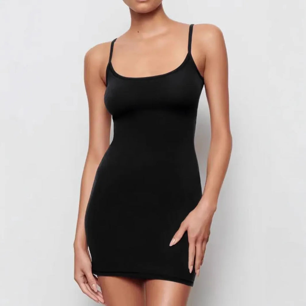 Black sleeveless sling dress with a short skirt and a slim sheath silhouette on a mannequin.