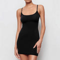 Black sleeveless sling dress with a short skirt and a slim sheath silhouette on a mannequin.