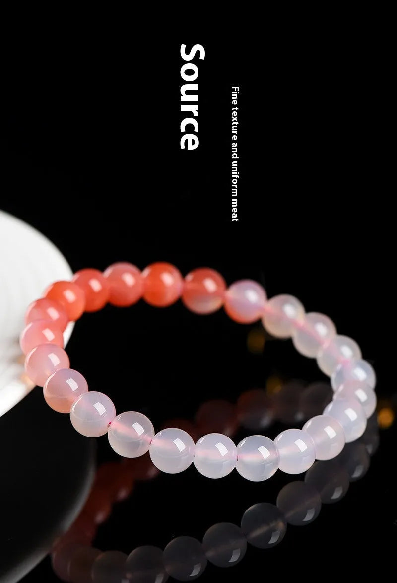 Natural gradient Yanyuan agate bracelet with geometric beads on a wrist.