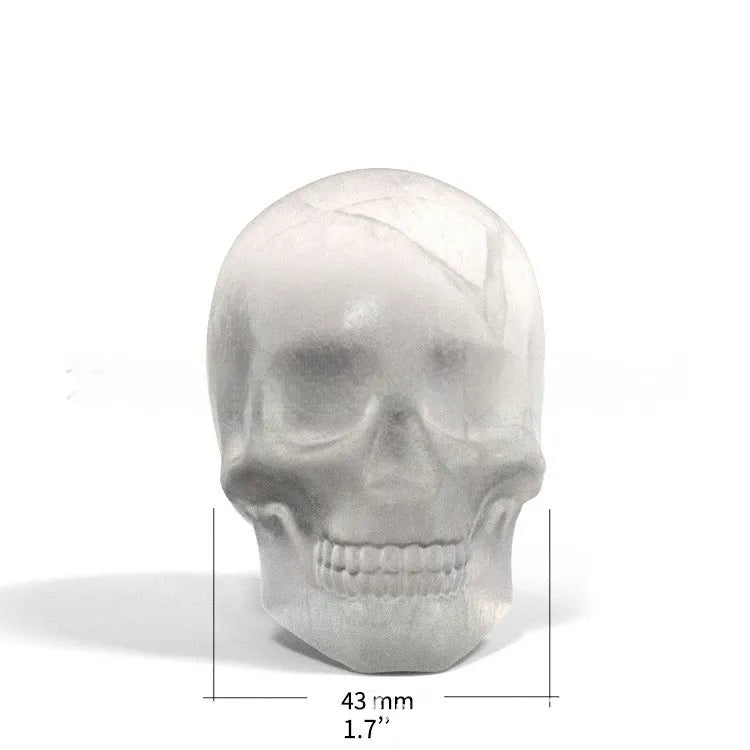 3D Halloween skull ice cube tray made from blue food-grade silicone on a white background.