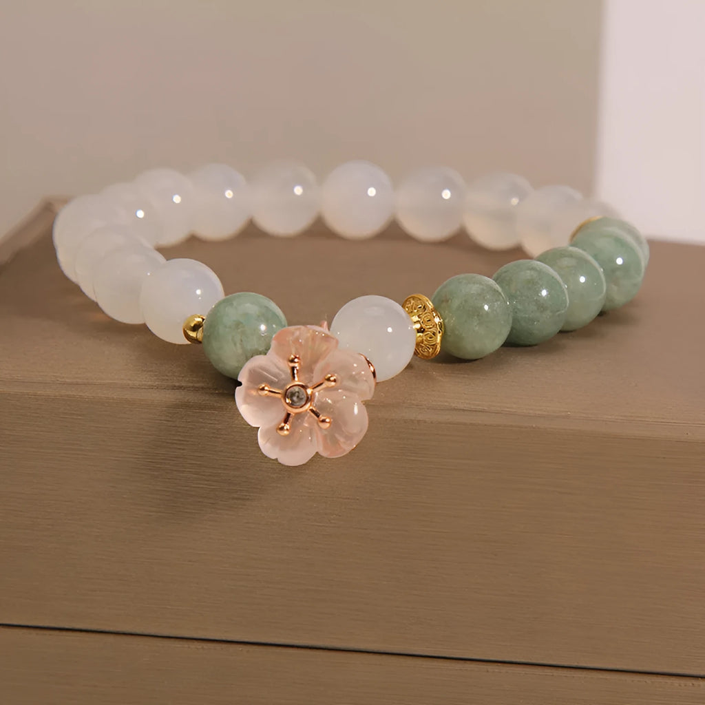 Jade floral bracelet with white agate jadeite stone and pink flower details on wrist