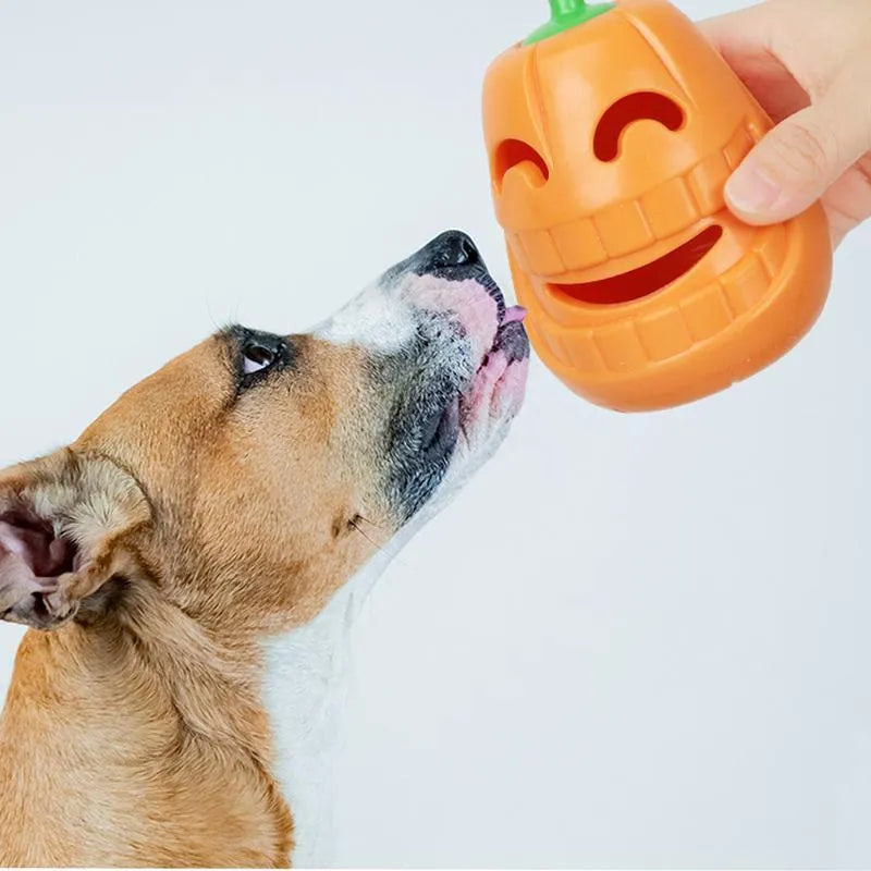 Yellow pumpkin-shaped tough TPR chew toy for dogs on a white background.