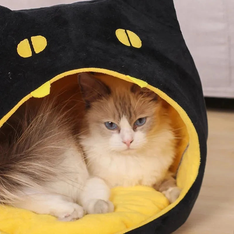 Enclosed cat-shaped pet bed with plush fabric and covered cave design