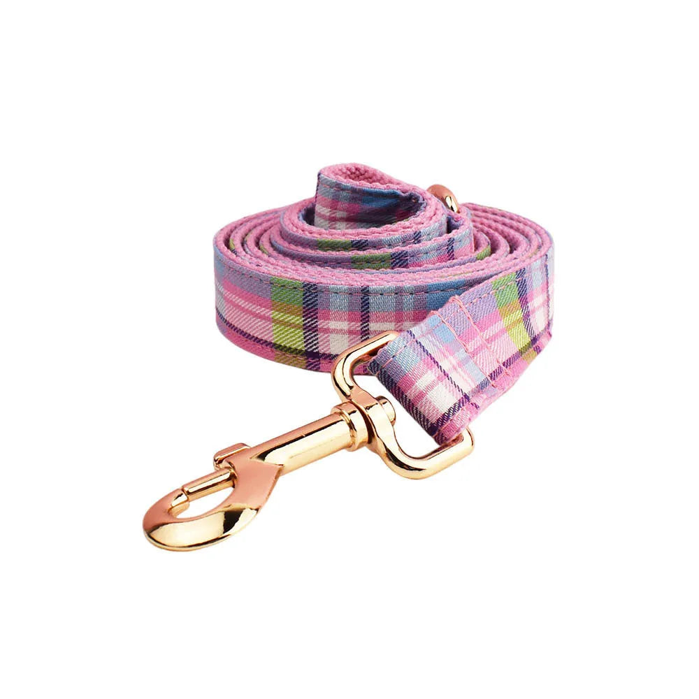 Four-piece cloth dog accessory set showing collar, leash, bow, and vest for small to large dogs.