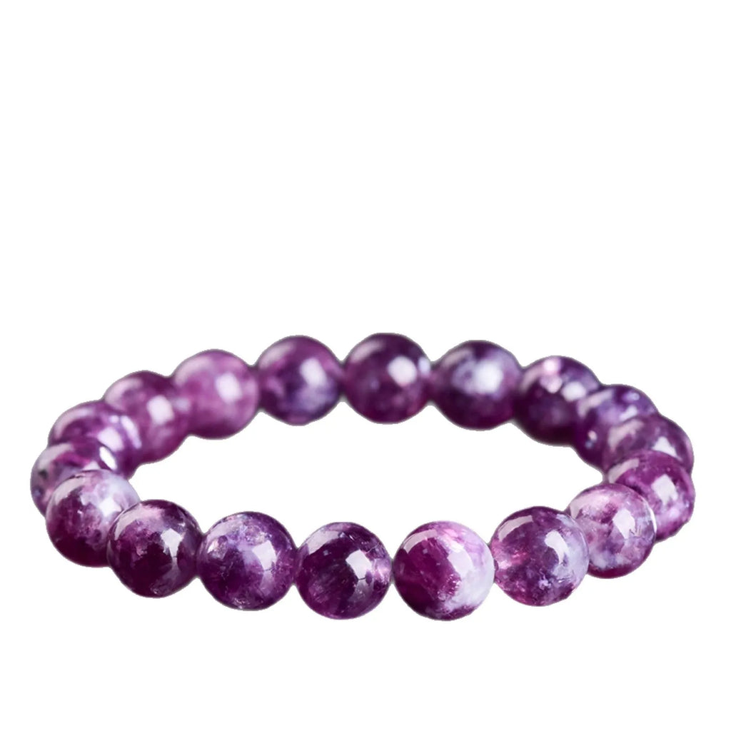 Polished purple crystal bracelet with geometric beads on a white background.