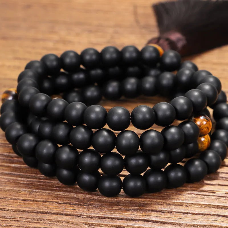 Tiger eye stone beaded necklace and bracelet set with tassel pendants on white background