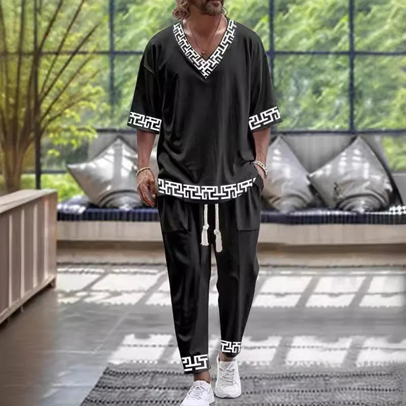 Casual trousers suit with V-neck cropped sleeve jacket and matching trousers in thin polyester.
