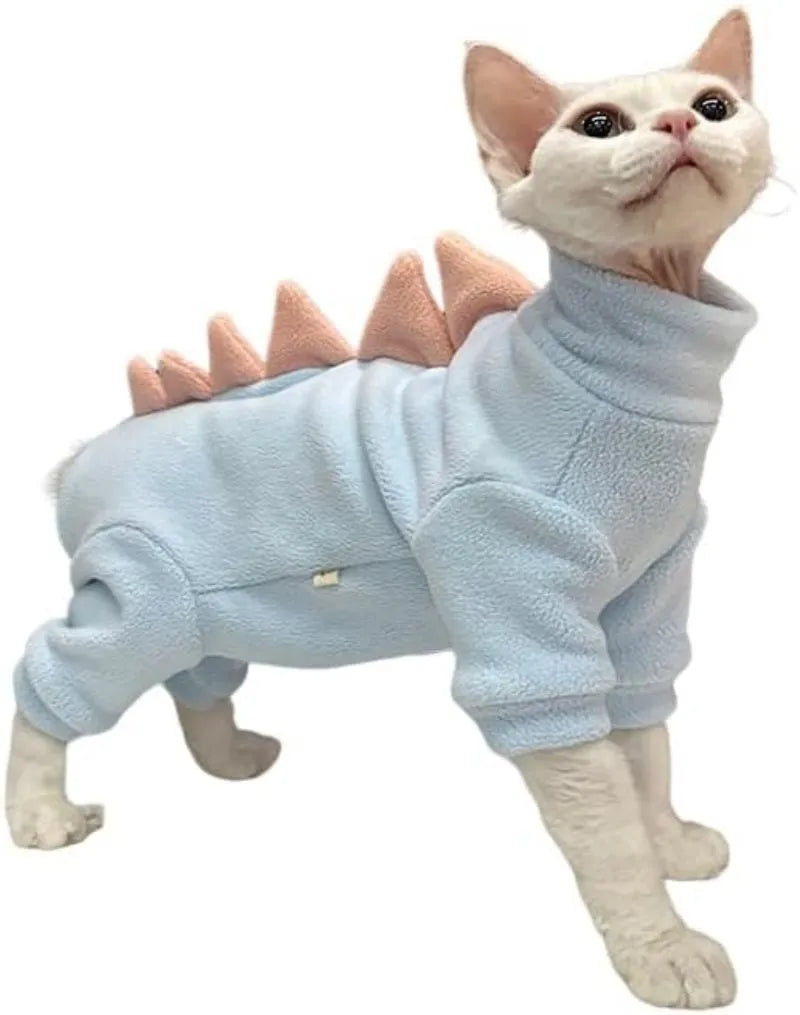 Sphynx cat wearing dinosaur costume with tail and back spikes, made from fleece material