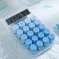 Round mechanical keyboard calculator in a muted colour with large LCD display on desk.