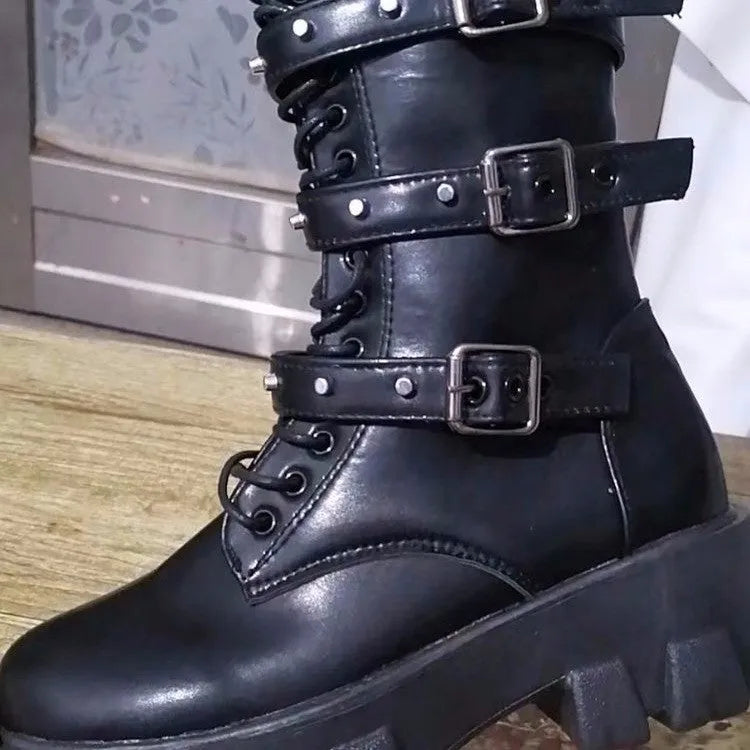 Women's black mid-calf knight boots with a large metal buckle and side zipper detail.
