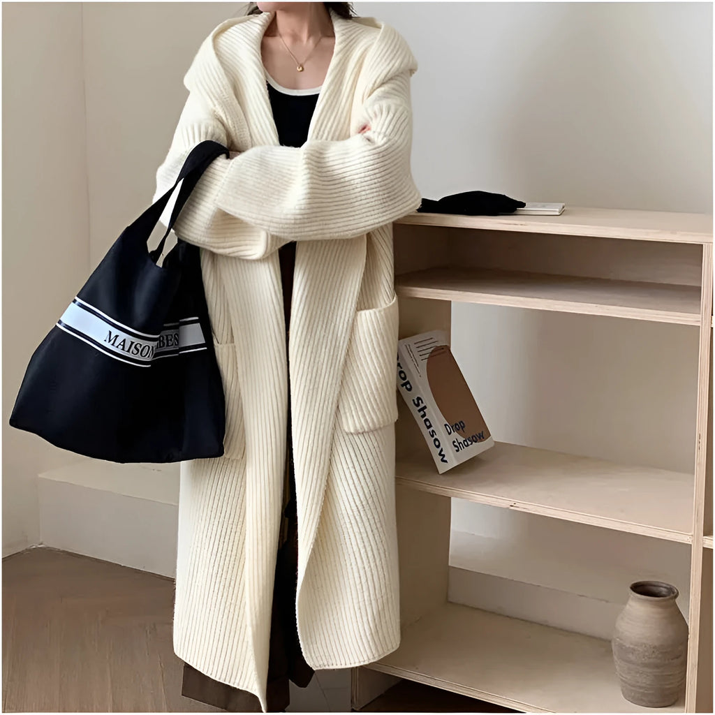 Loose grey hooded cardigan coat with long sleeves on a hanger