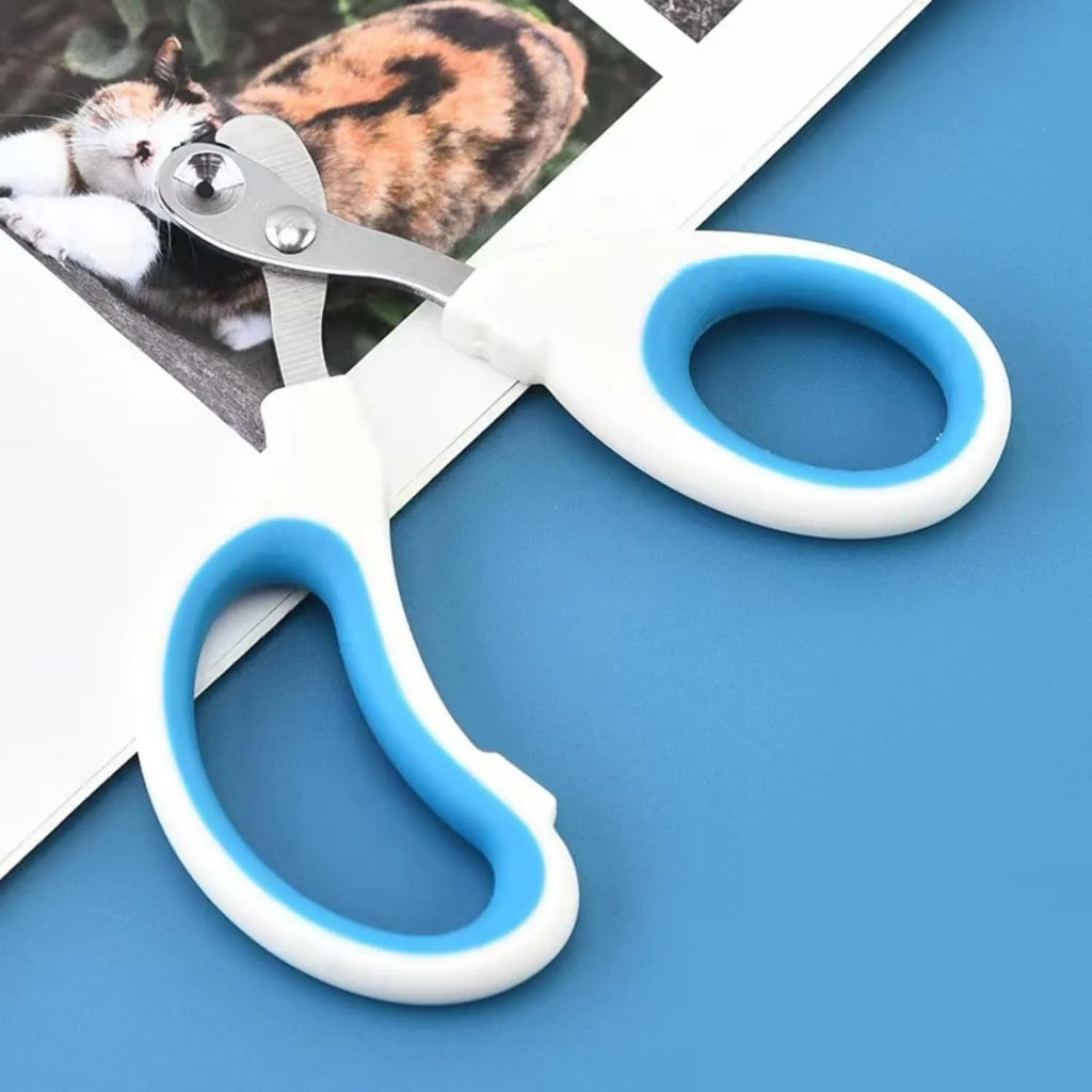 Blue pet nail clippers with a circular guide hole and cushioned handles on a white surface.
