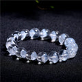 Women's white crystal bracelet with a ghost pyramid centrepiece and a traditional Ruyi charm.