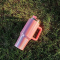 Large stainless steel vacuum cup in a rainbow colour gradient showing its size and lid.