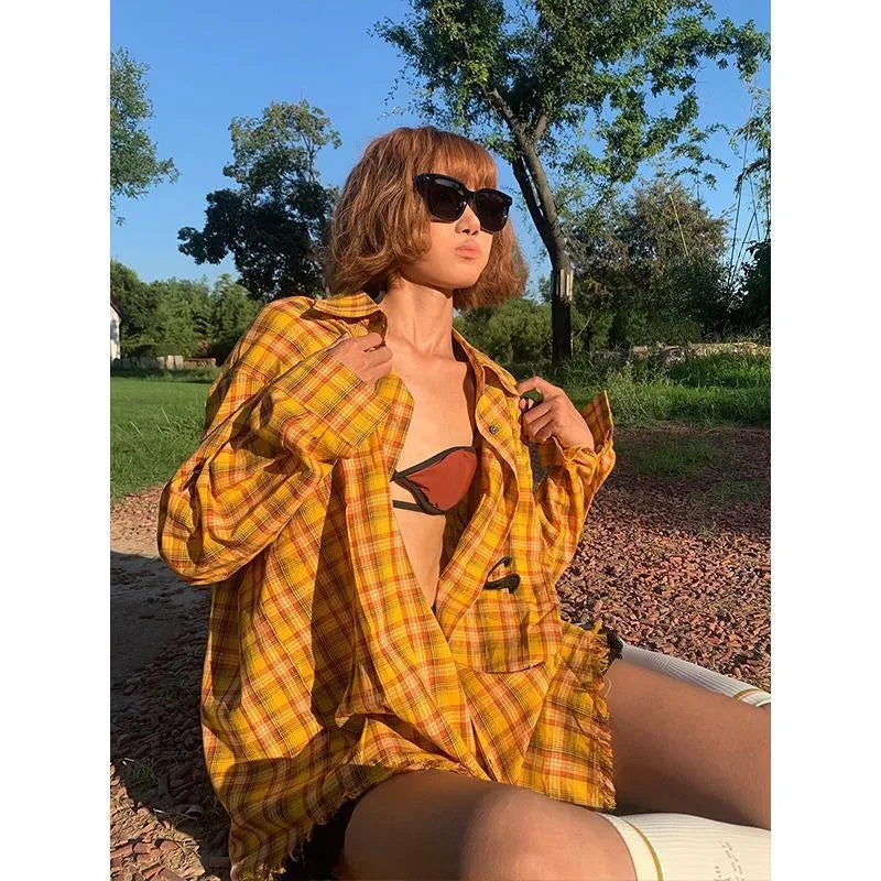 Dopamine yellow plaid shirt with a loose, cardigan-style fit on a hanger.