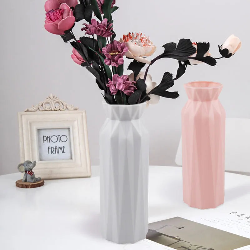 A green drop-resistant plastic melamine vase with a wide 7.2cm base on a wooden table.