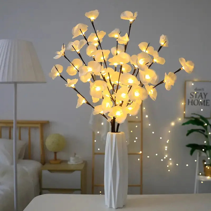A 65cm long pink LED phalaenopsis branch decorative light on a dark background.