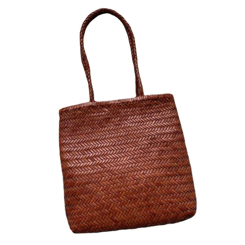 Brown handmade woven cowhide leather tote bag with a three-dimensional front pocket.
