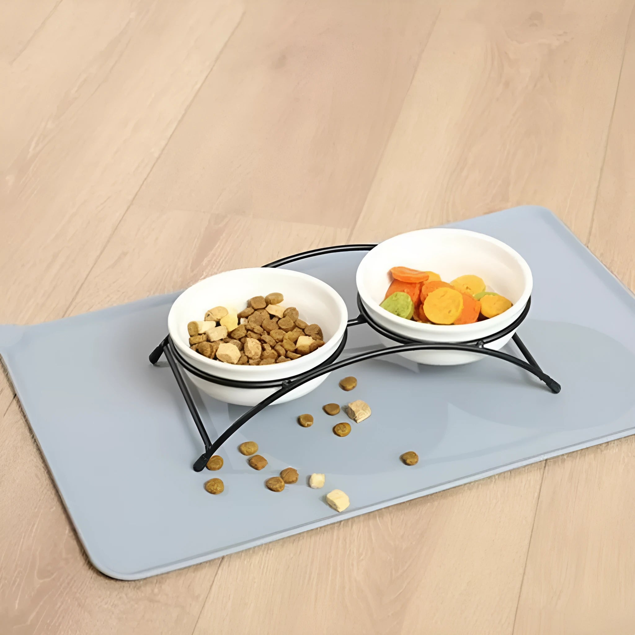 Large grey silicone pet placemat with a raised edge, holding a dog bowl on a wooden floor.