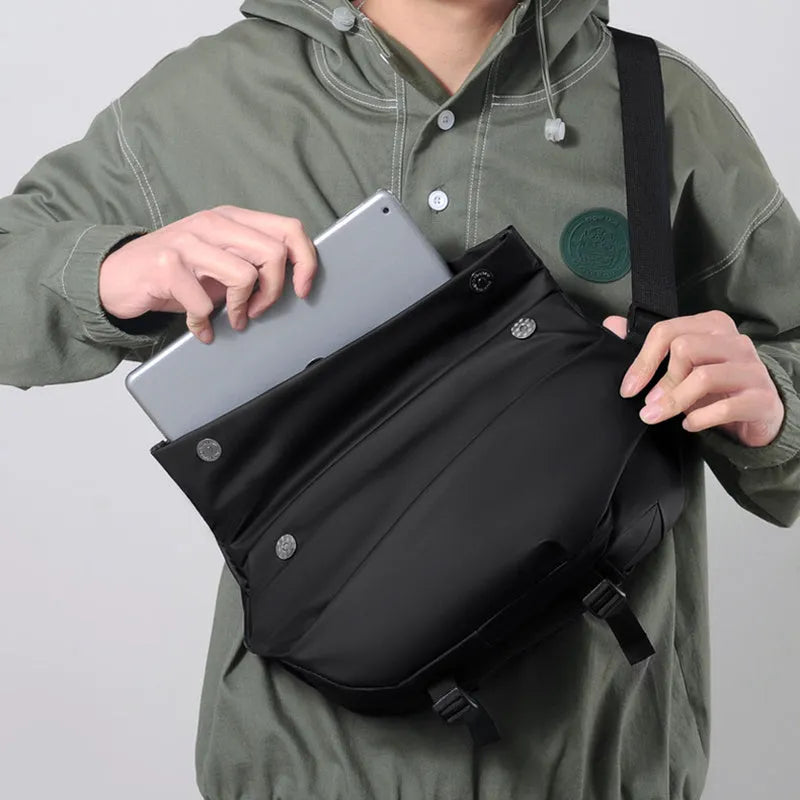 A grey medium-sized horizontal square PU crossbody bag for men, showing the shoulder strap and front zipper.