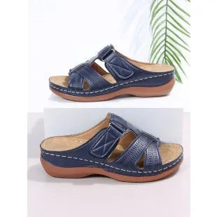 Women's black wedge sandals with a peep toe and Velcro fastening strap on a white background.