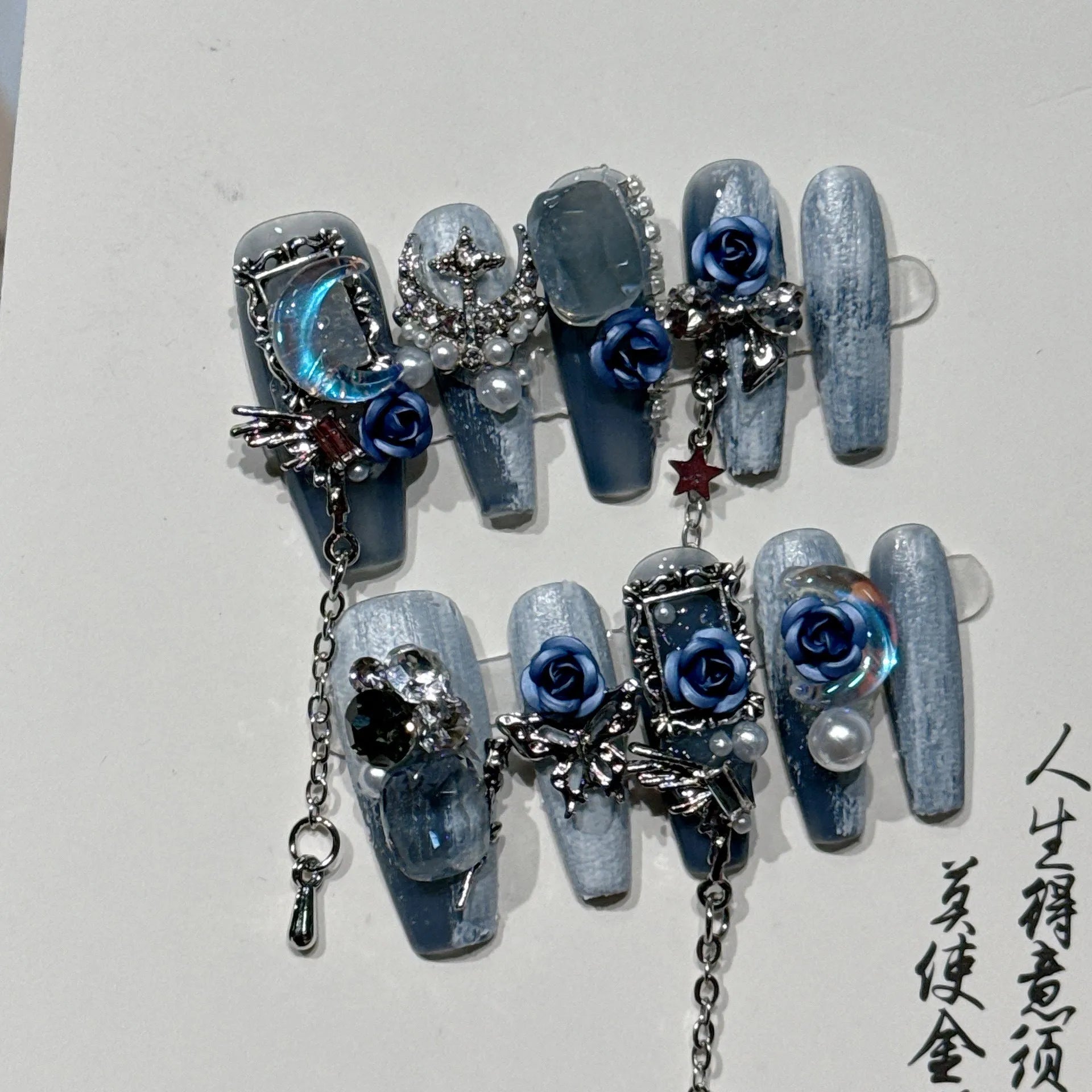 Blue false nails with rose and flower pattern, shown in a set with sizes XS, S, M, L.