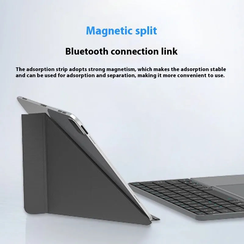 Grey folding Bluetooth keyboard shown open next to a mobile phone.