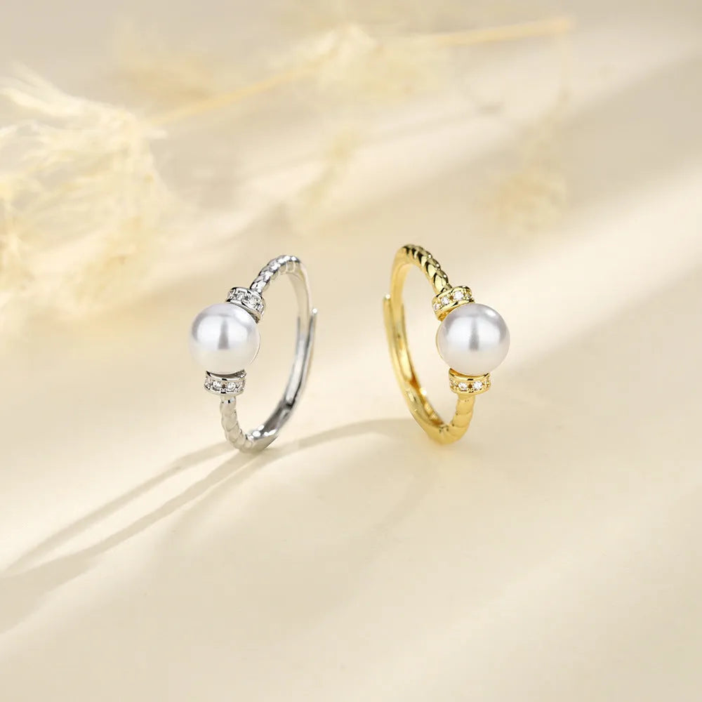 Adjustable antique twist copper ring with a geometric pearl centre in gold and silver colours.
