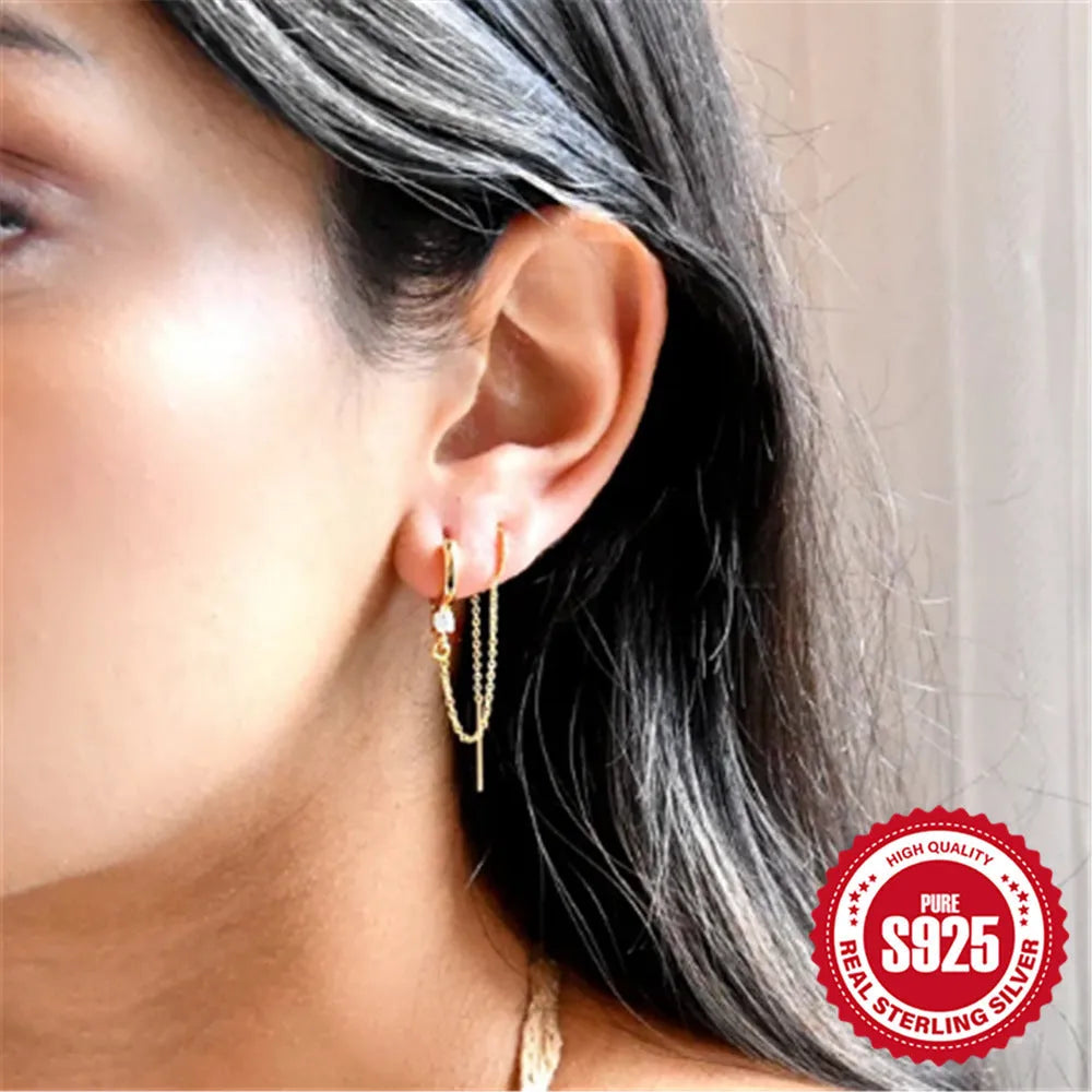 S925 sterling silver stud earring with a diamond-shaped flower, dangling tassel, and chain detail in a golden colour.
