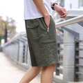 Man wearing light grey loose-fit straight-leg cotton summer trousers