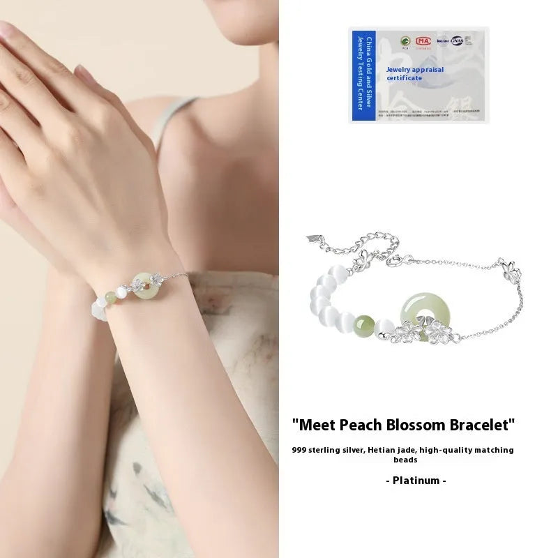 Women's silver peace buckle bracelet with floral design and safety closure mechanism in gold electroplated finish