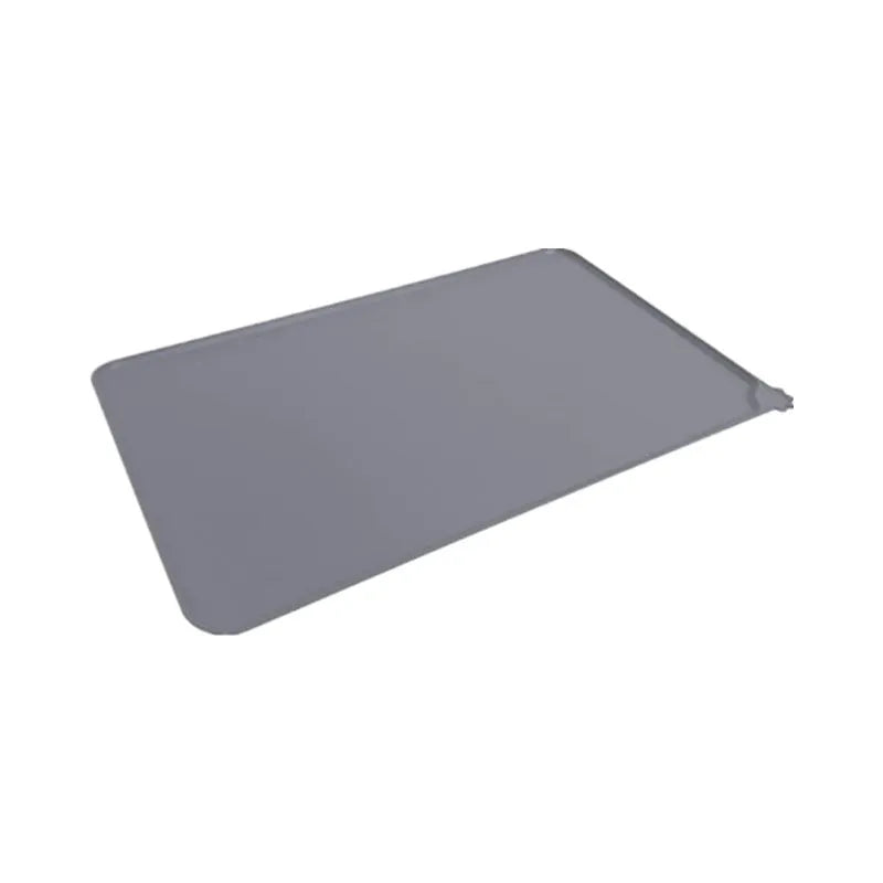Large grey silicone pet placemat with a raised edge, holding a dog bowl on a wooden floor.