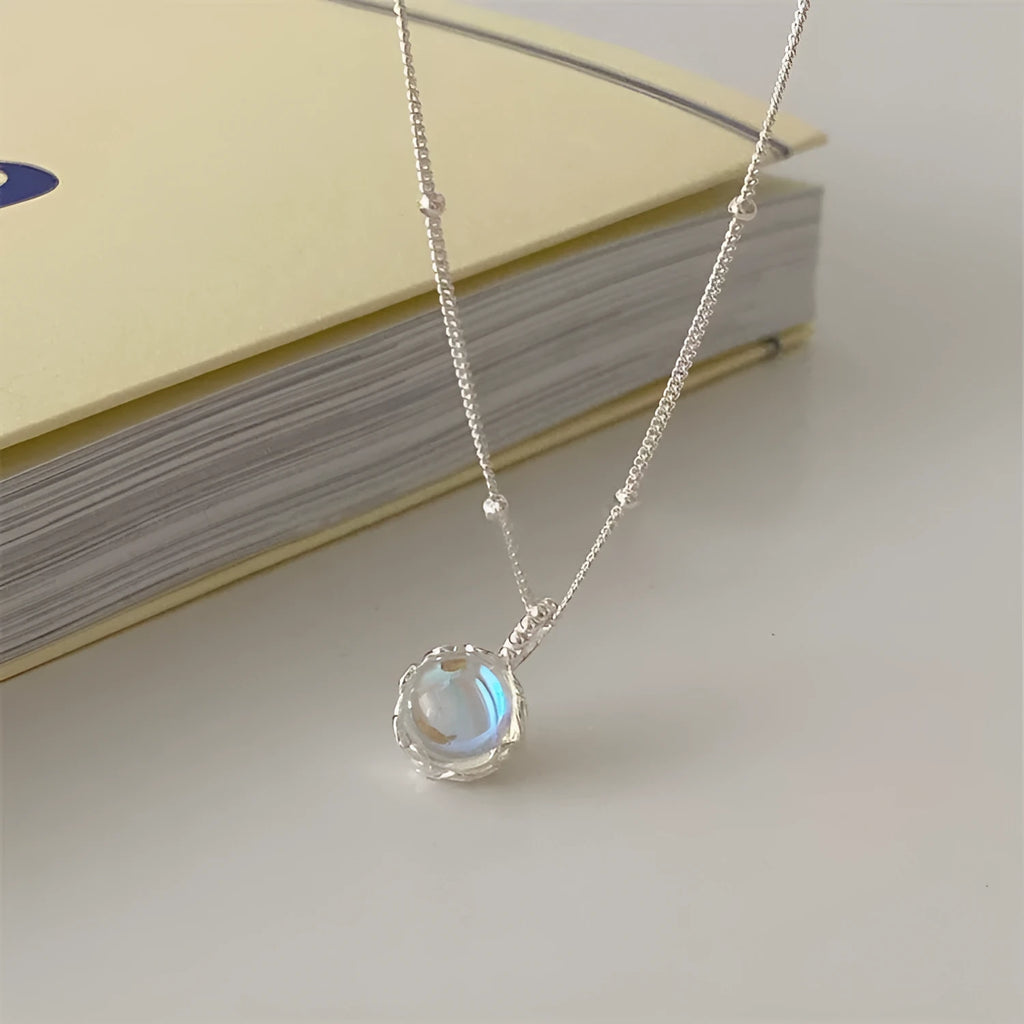 Silver geometric pendant on a sterling silver curb chain necklace for women.