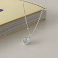 Silver geometric pendant on a sterling silver curb chain necklace for women.