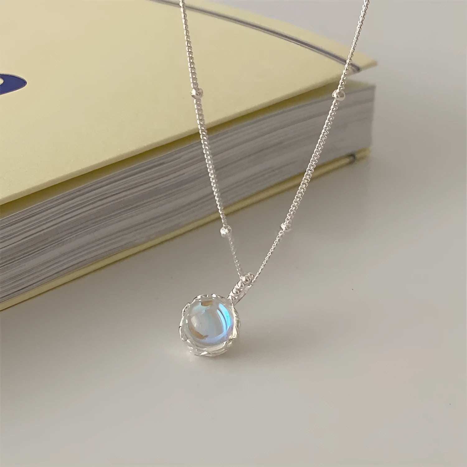 Silver geometric pendant on a sterling silver curb chain necklace for women.