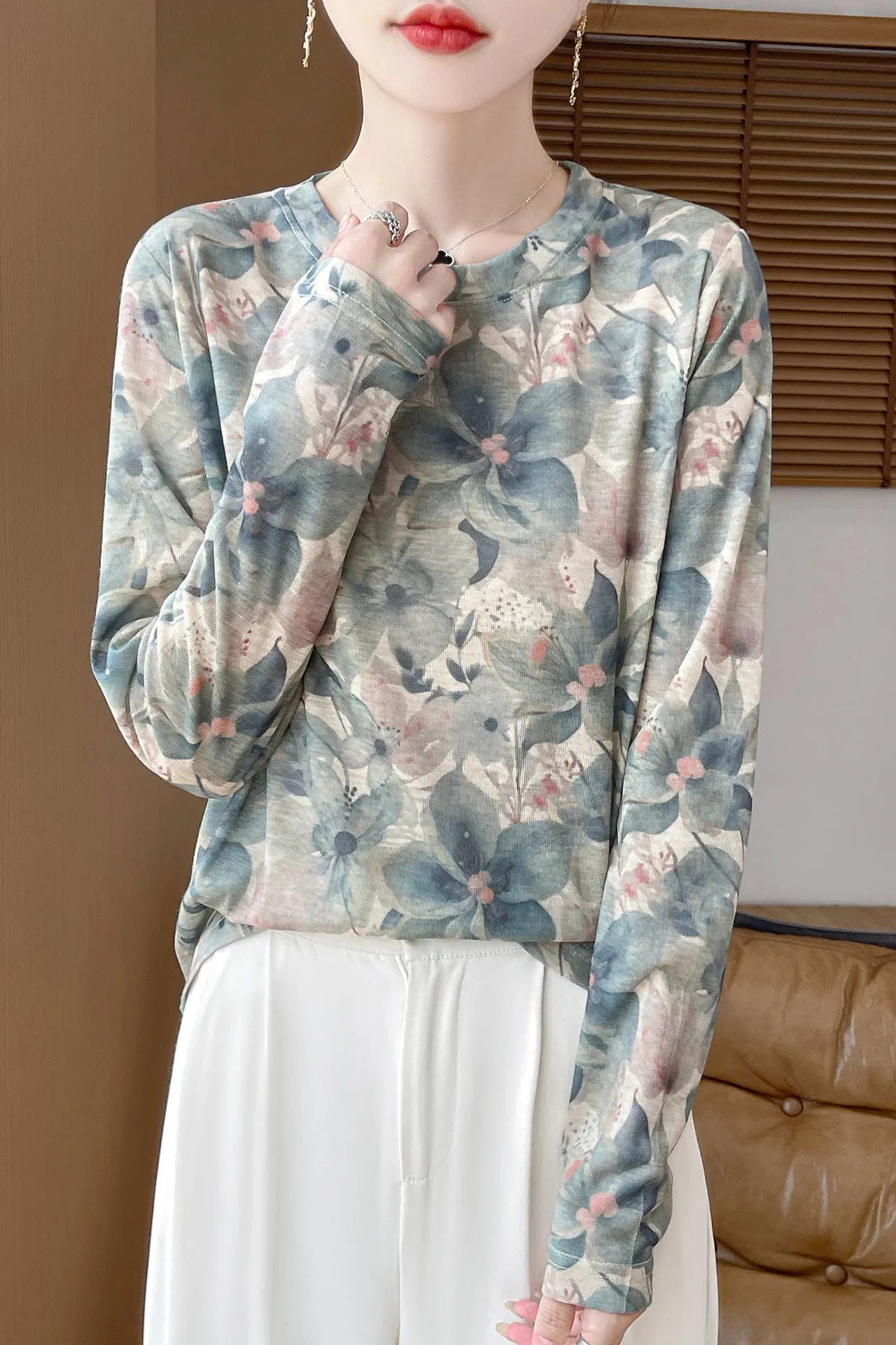 Round neck Tencel cotton pullover shirt with a colourful floral print, shown on a hanger.