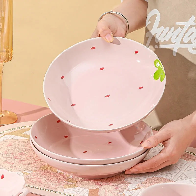 Porcelain dinnerware set with strawberry pattern includes bowls, plates, and spoon
