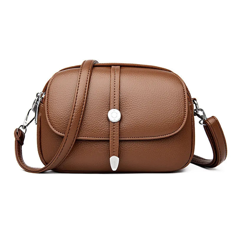 Soft PU oval-shaped women's crossbody shoulder bag in dark brown with sewing thread details.