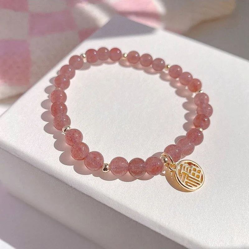 Strawberry quartz glass blessing card bracelet with adjustable clasp on wrist