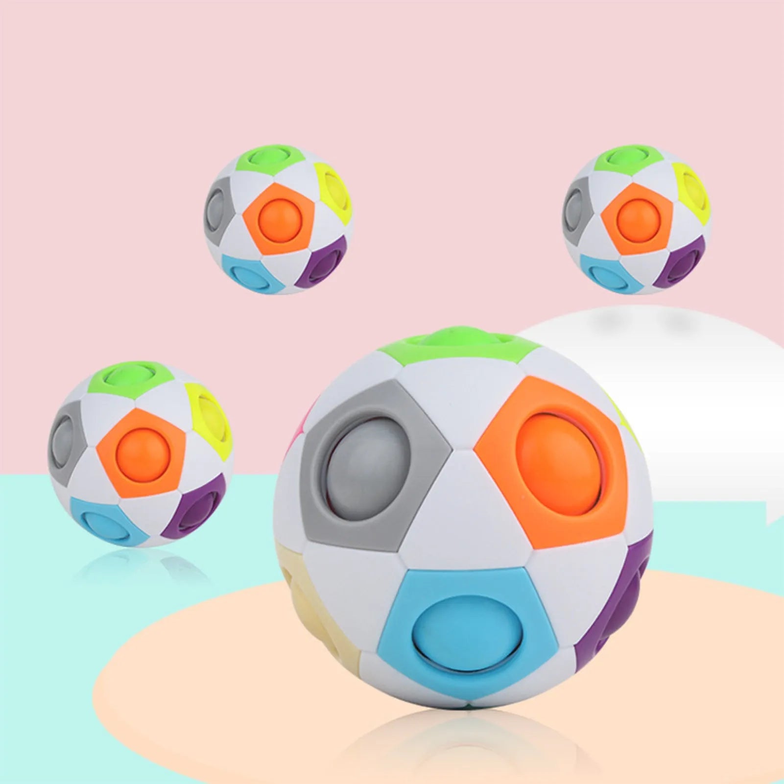 A 5.5 cm diameter rainbow-coloured plastic puzzle ball with a hexagon pattern.