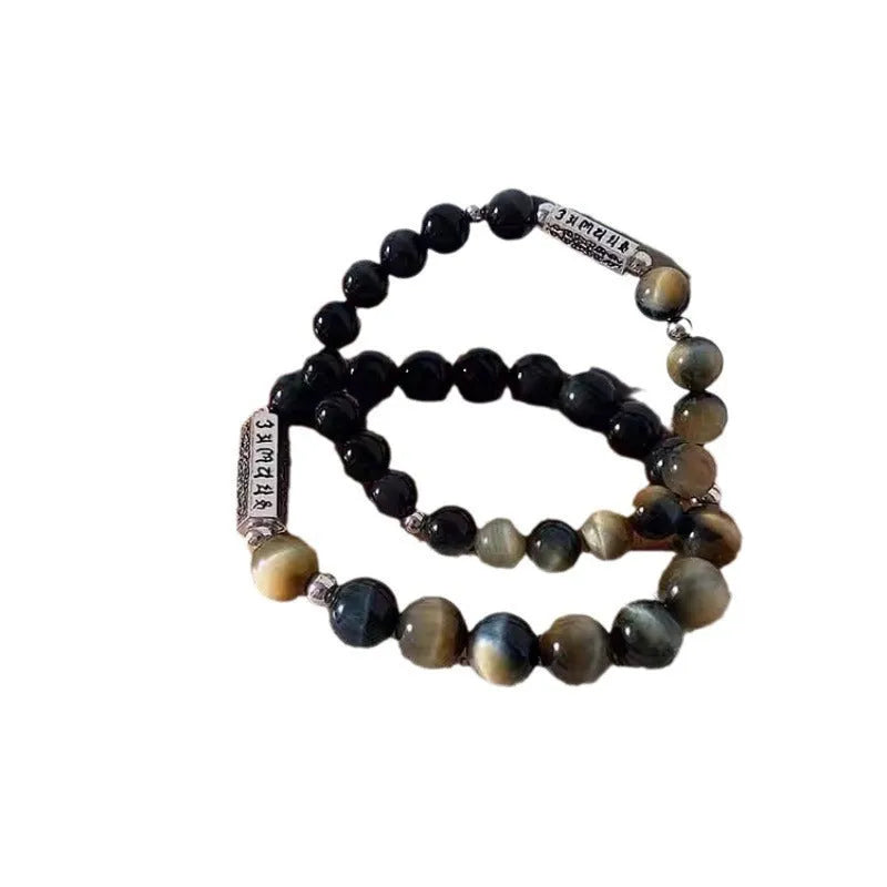 Sterling silver bracelet with obsidian and tigereye stone beads showing geometric round design and mantra engraving