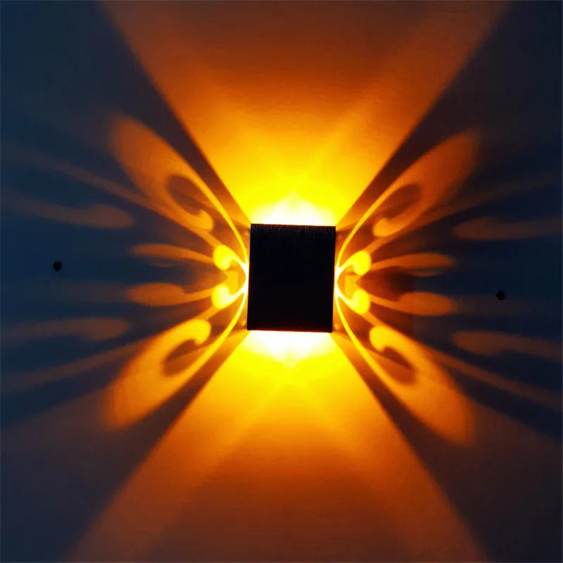 Modern aluminium LED butterfly wall lamp with remote control showing colour changing functionality