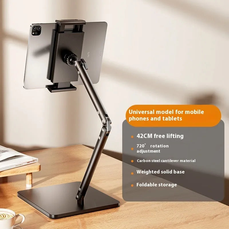 Silver alloy desktop phone bracket with double arms holding a smartphone, shown with a remote control on a wooden desk.